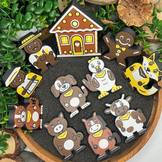 Gingerbread Man 11 piece story set laid out in a wooden tray with dark sand