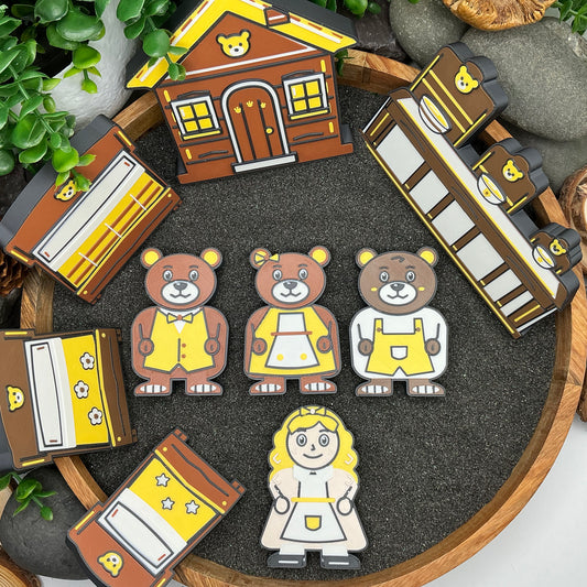 Large nine-piece Goldilocks and the Three Bears story set laid flat in a wooden sand tray, with four characters, three beds, table scene and cottage