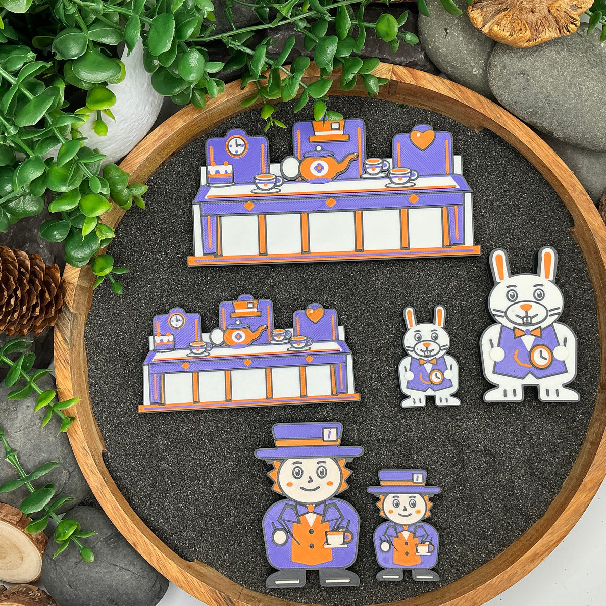 Large and Small tea-party scenes, White Rabbit and Mad Hatter figures compared from above