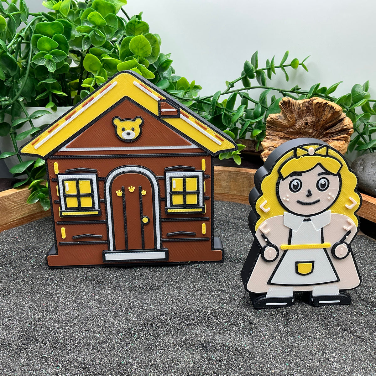 Large Goldilocks figure standing beside the Three Bears cottage