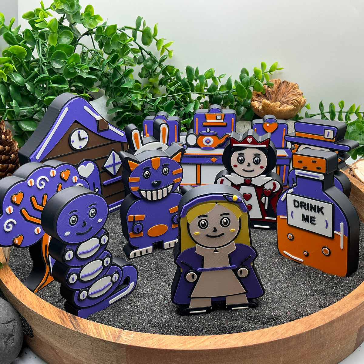 Large blonde-haired Alice in front of the other Wonderland characters and four scenery pieces
