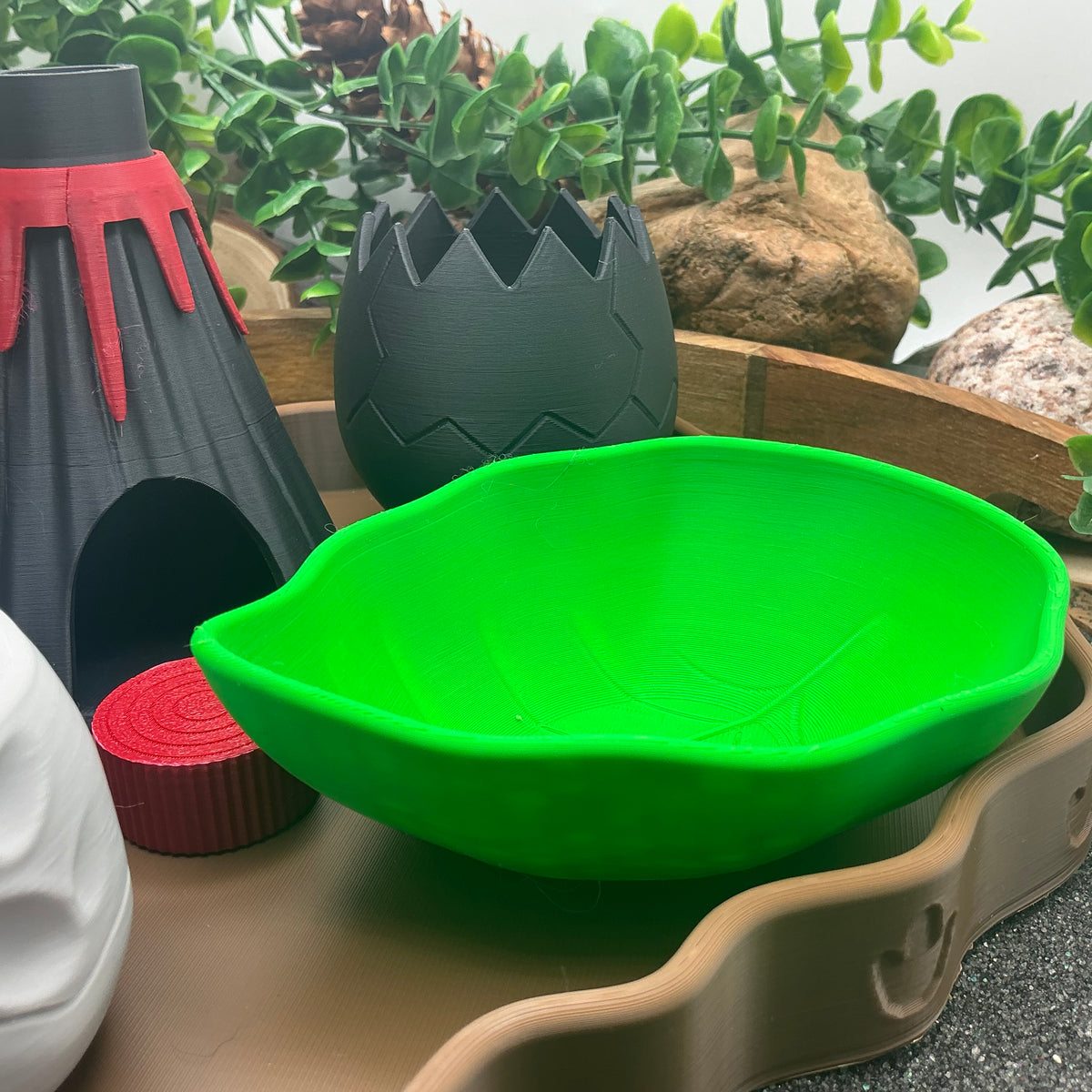 Volcano, cracked dinosaur egg and green leaf bowl
