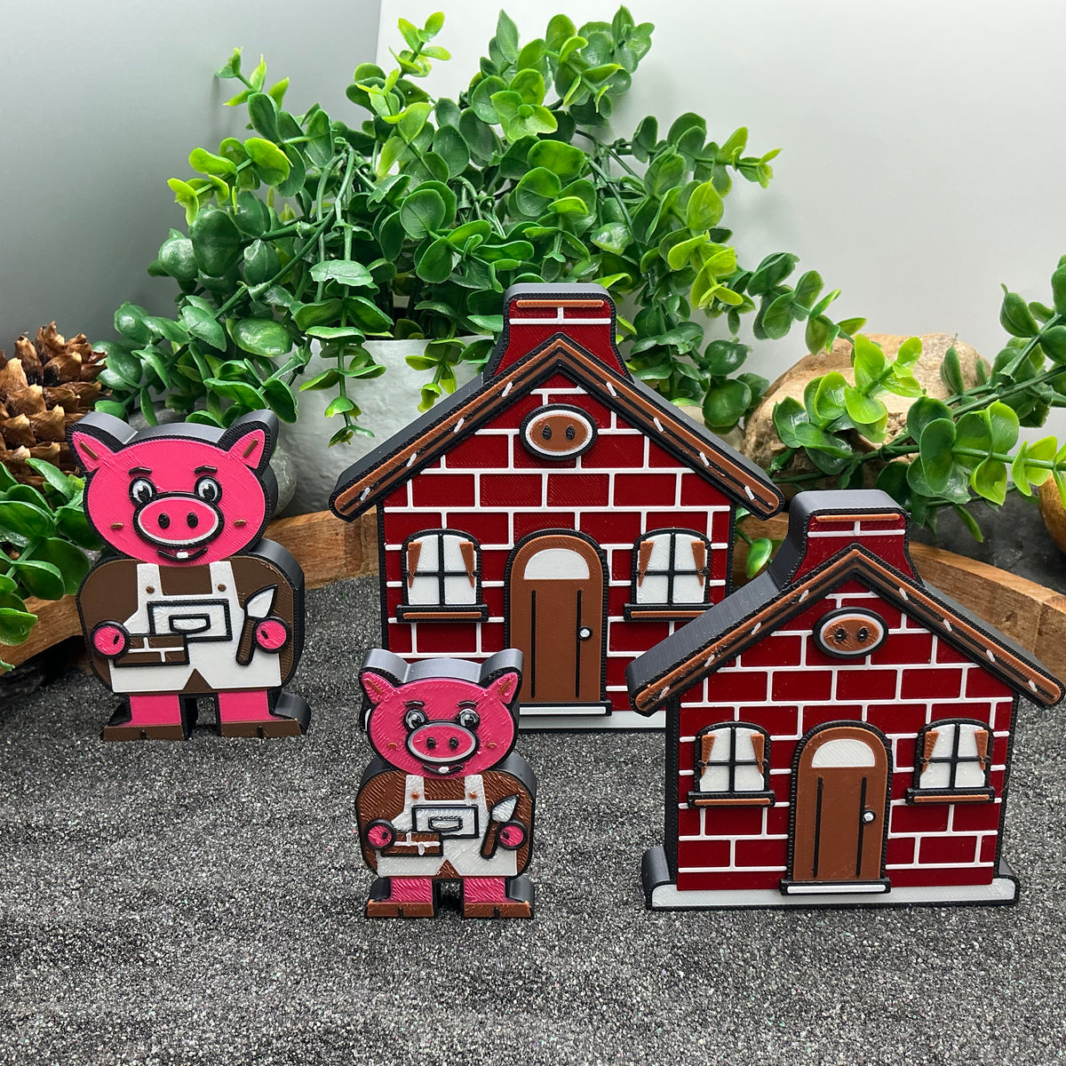 Large and Small pig figures beside red brick houses in two sizes