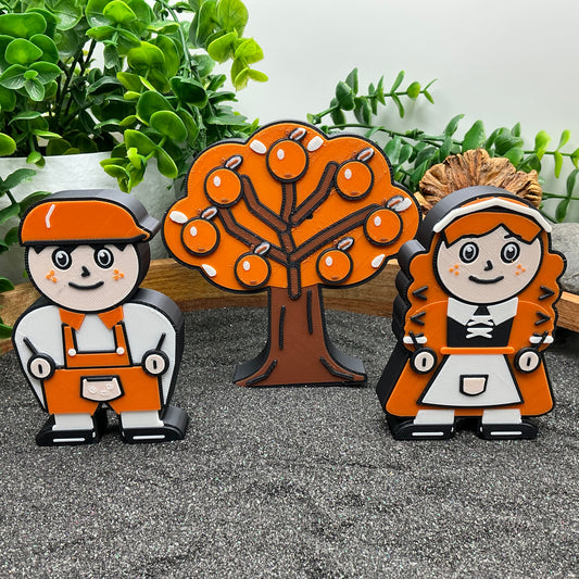 Large Hansel and Gretel characters with an orange tree in a wooden sand tray