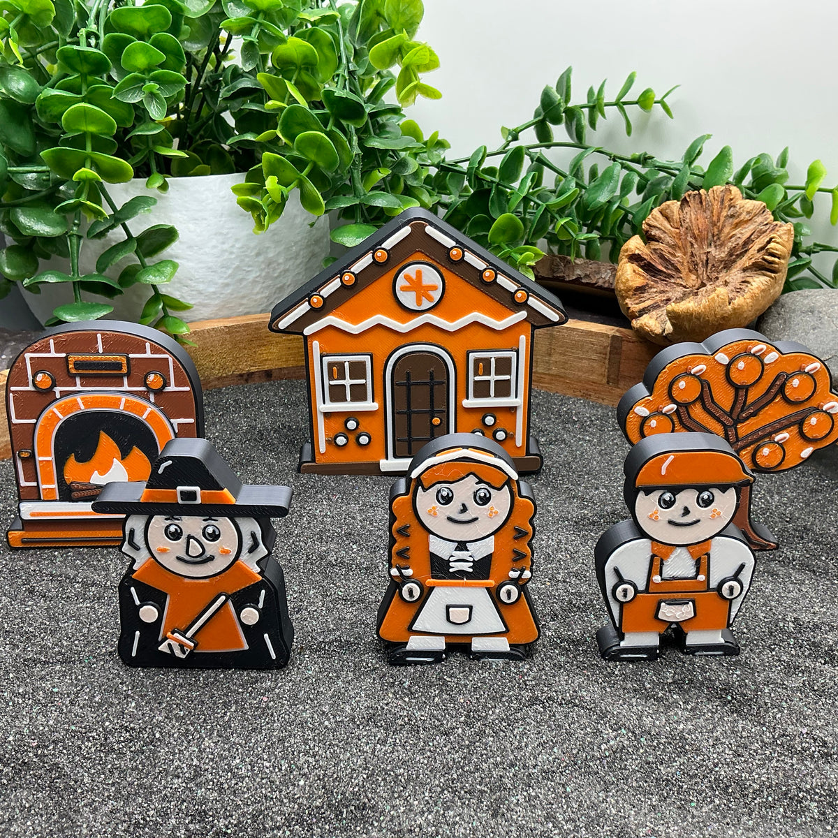 Small witch, Gretel and Hansel with a gingerbread cottage, oven and orange tree