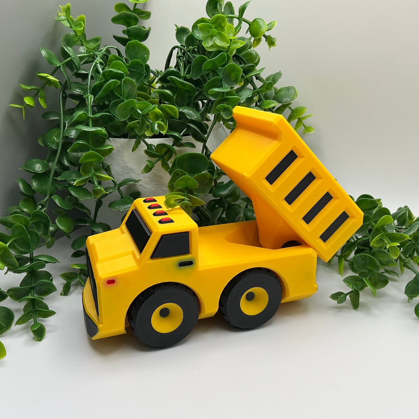Large 3D-printed multi-coloured dump truck construction vehicle with tipper bed - view 3 of 5