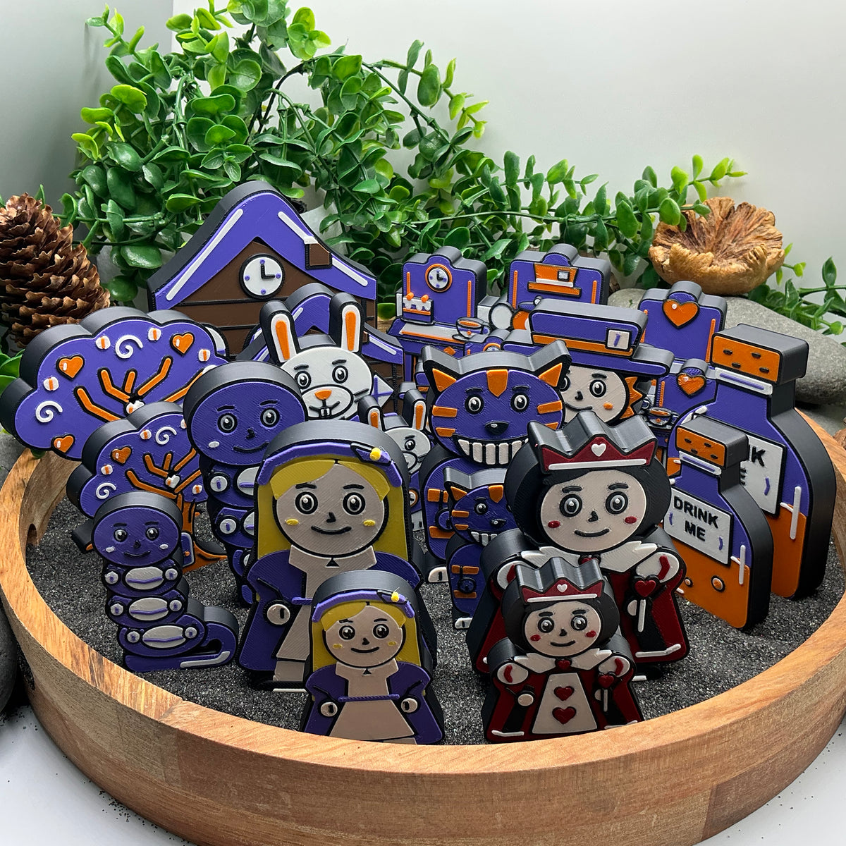 Large and Small Alice in Wonderland sets displayed together for comparison