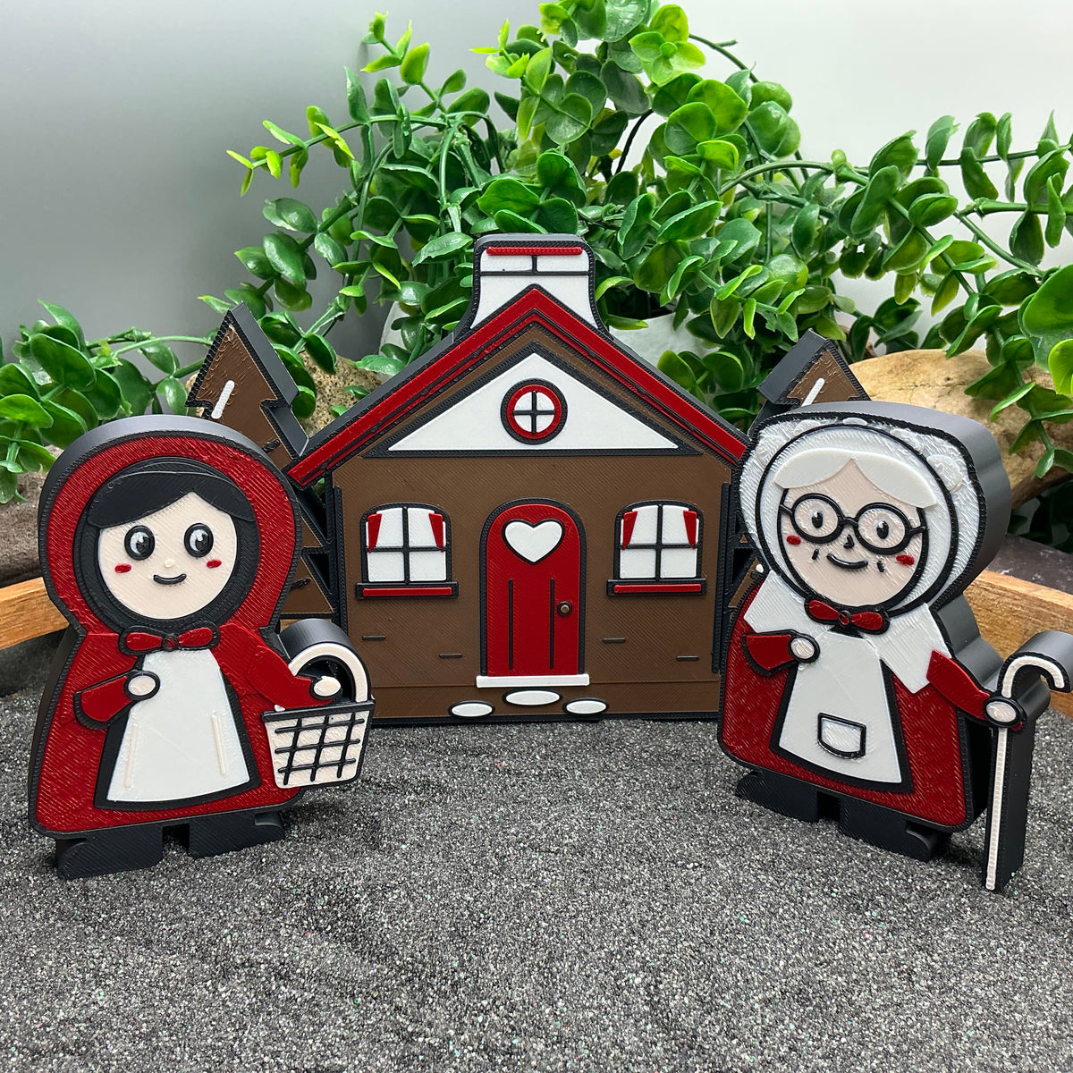 Little Red Riding Hood and Grandma beside the cottage