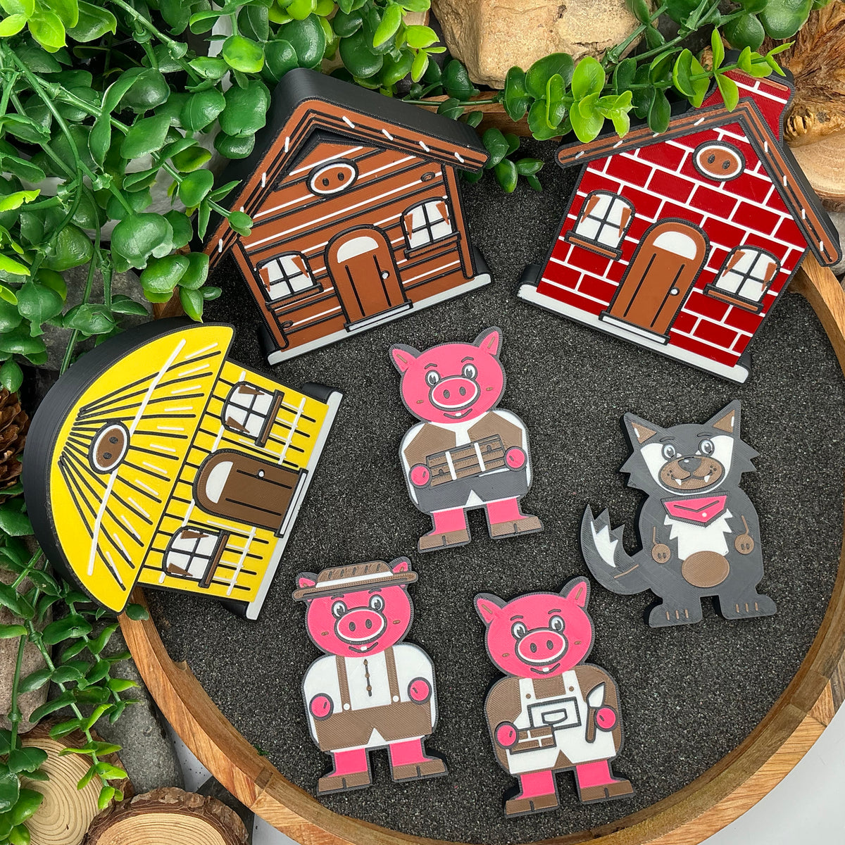 Small Three Little Pigs story set laid out in a wooden tray with dark sand
