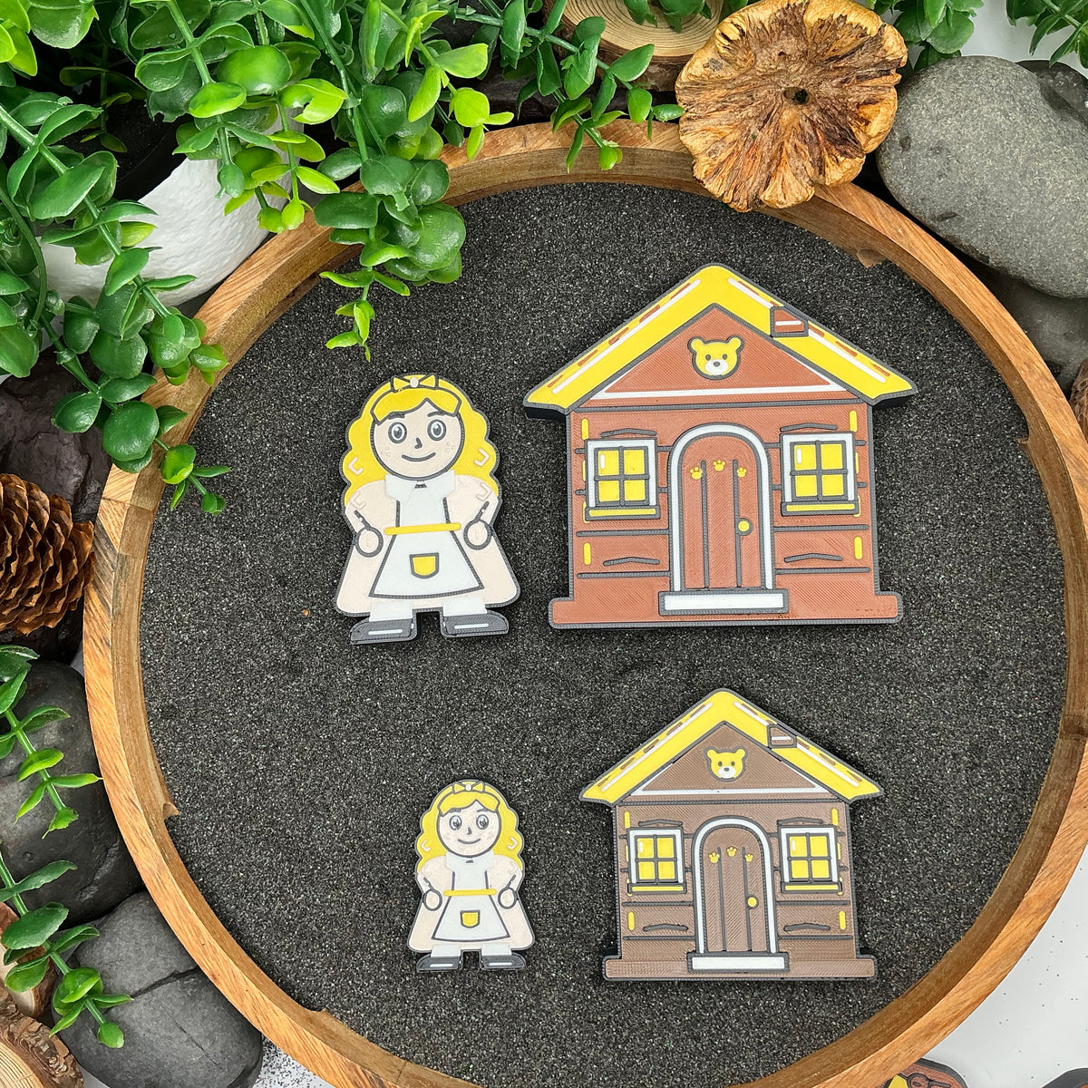 Large and Small Goldilocks figures and cottages laid out side by side