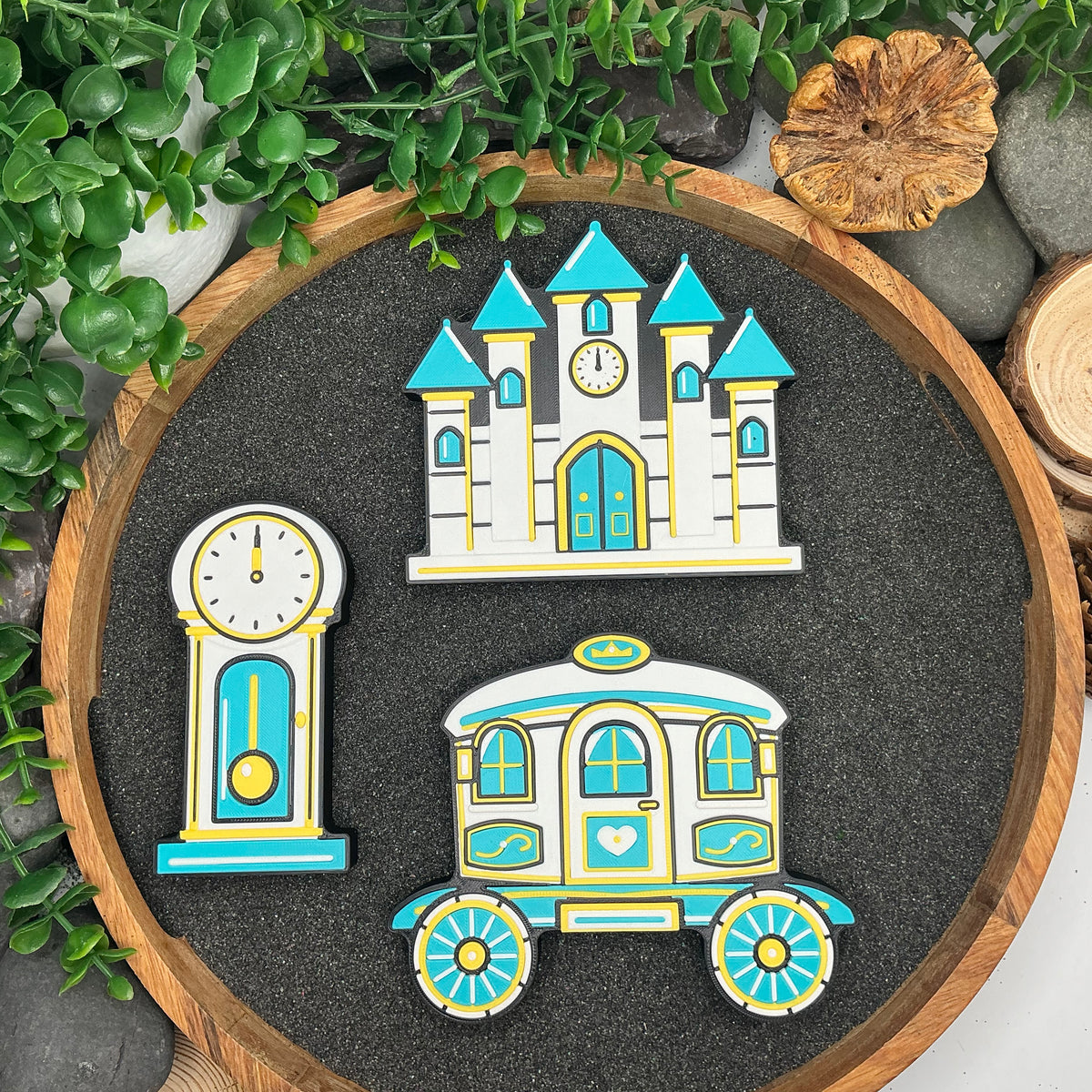 Large Cinderella castle, grandfather clock and royal carriage laid flat in a wooden tray