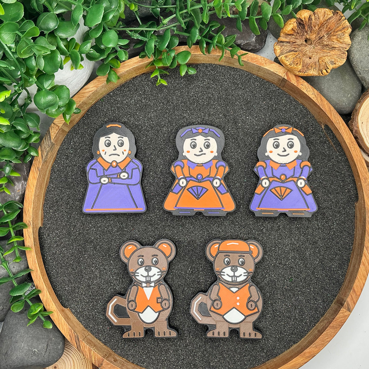 Large Cinderella stepmother, two stepsisters with purple and orange bows, and two mouse figures laid flat