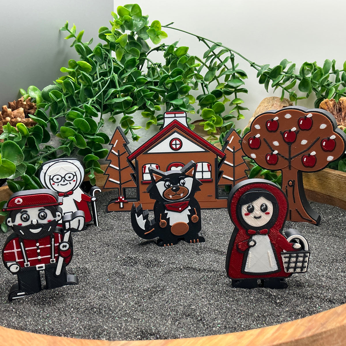 Little Red Riding Hood story characters standing in sand