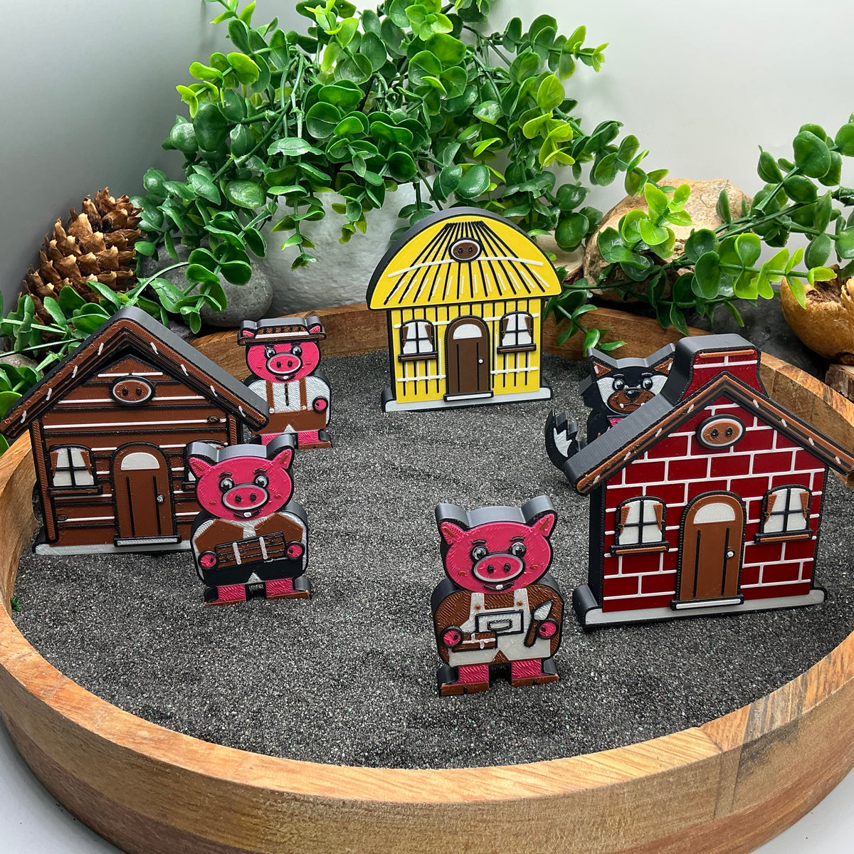 Small Three Little Pigs story scene with each pig beside a house and the wolf behind