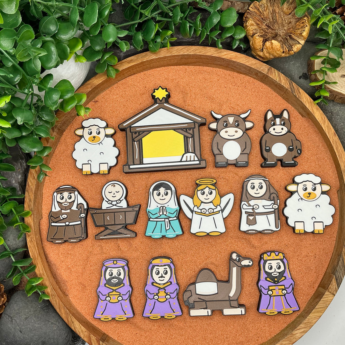 Complete 14-piece Nativity collection arranged flat, showing all characters, animals and the stable