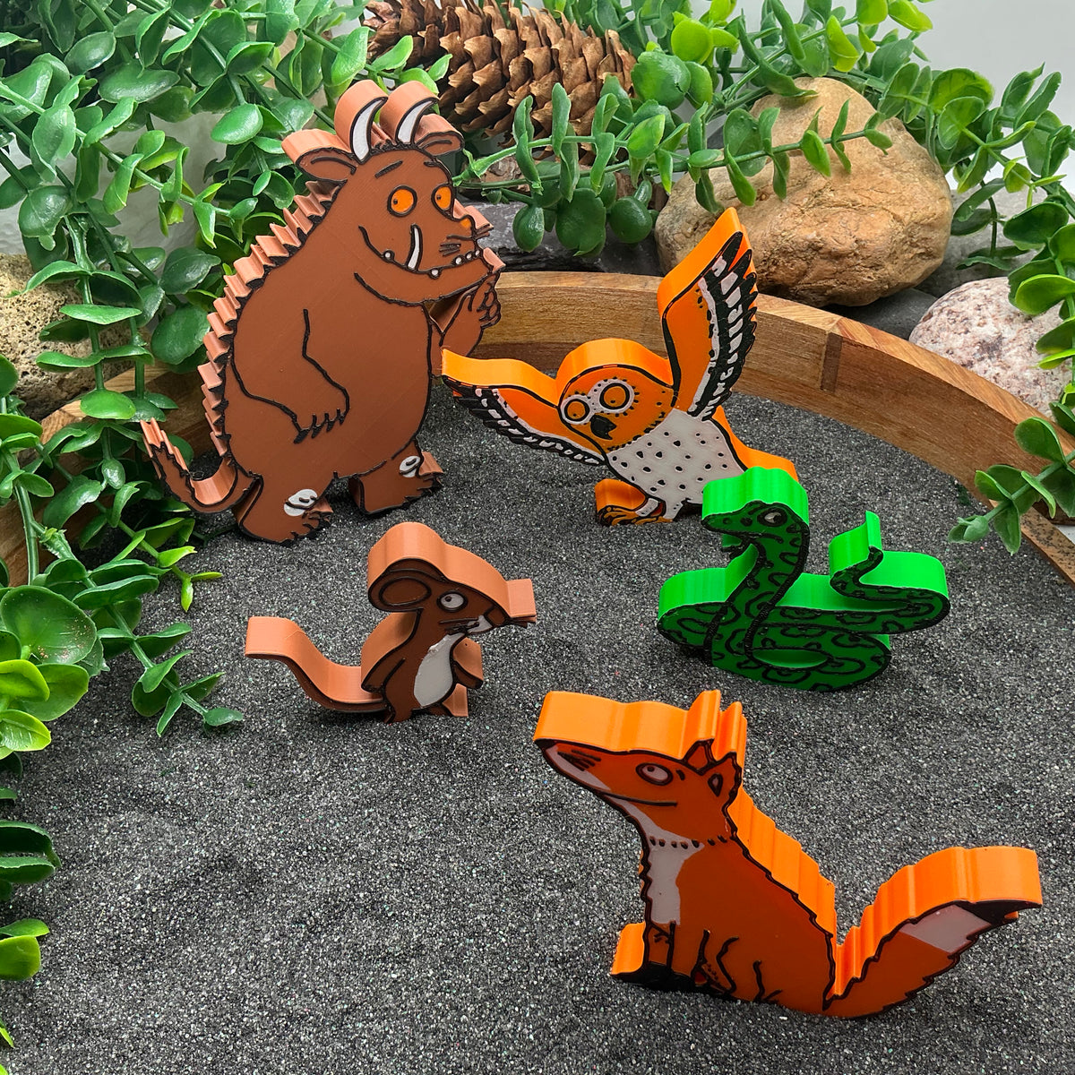Woodland story characters standing in a sand tray, side view