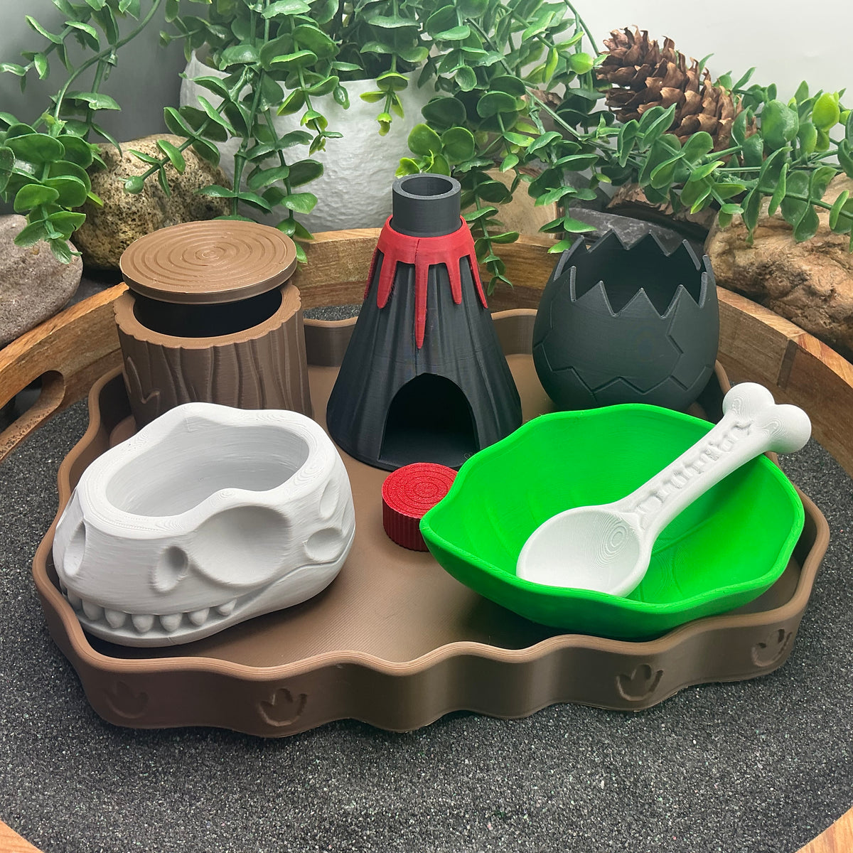 Dinosaur sensory kit 7 piece set with volcano, egg, skull bowl, leaf bowl and log pot on footprint tray