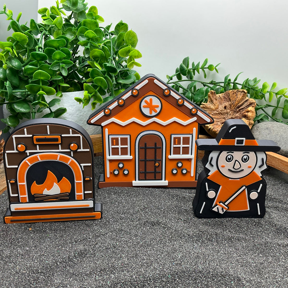 Large storybook oven, gingerbread cottage and witch standing in a sand tray