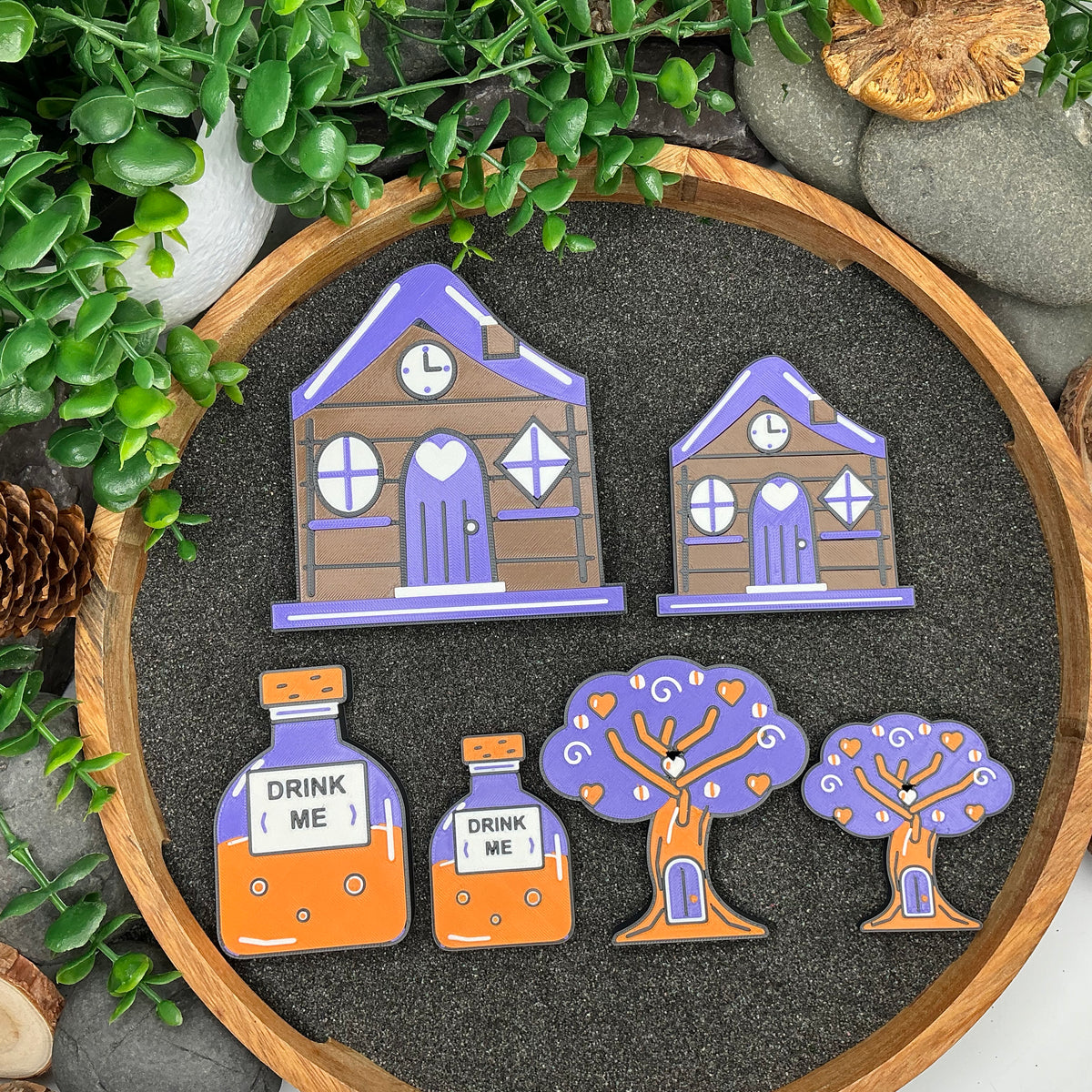 Large and Small Wonderland cottages, Drink Me bottles and tree pieces shown side by side
