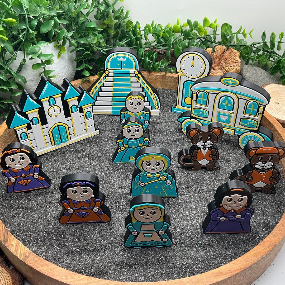 Cinderella story figures arranged in front of their castle, staircase, grandfather clock and royal carriage
