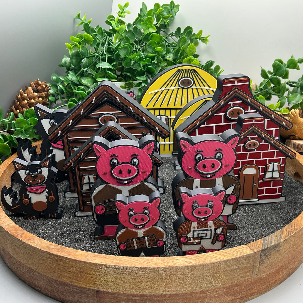 Large and Small Three Little Pigs characters and house pieces compared in a sand tray