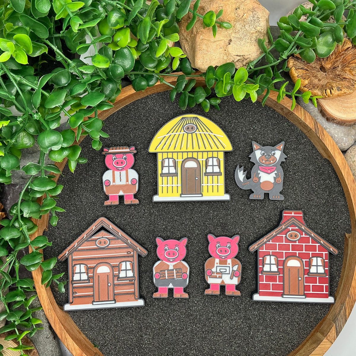 Small Three Little Pigs figures and three houses arranged in rows, viewed from above