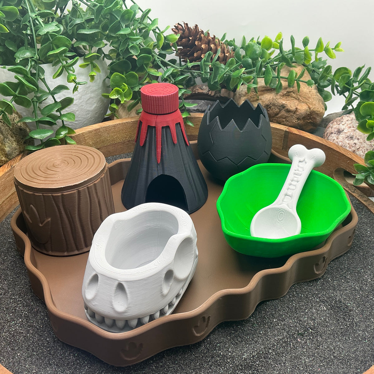 Dinosaur sensory kit front view with skull bowl, volcano, egg, leaf bowl and tree-stump pot