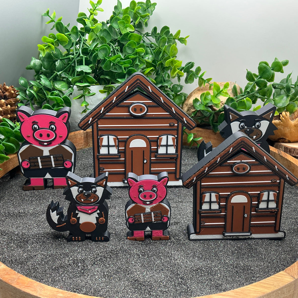 Large and Small pig and wolf figures beside brown stick houses in two sizes
