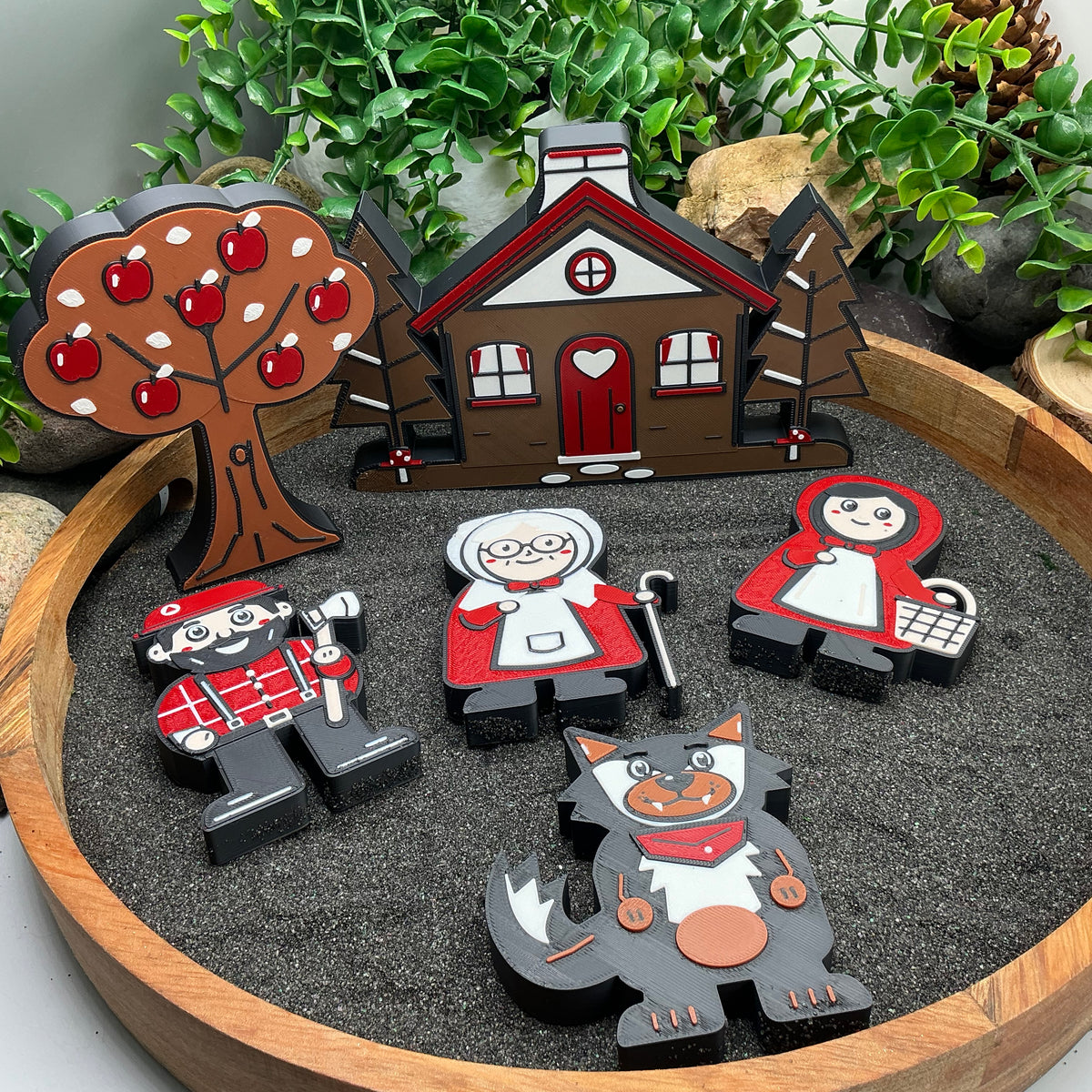 Little Red Riding Hood characters, cottage and apple tree from above