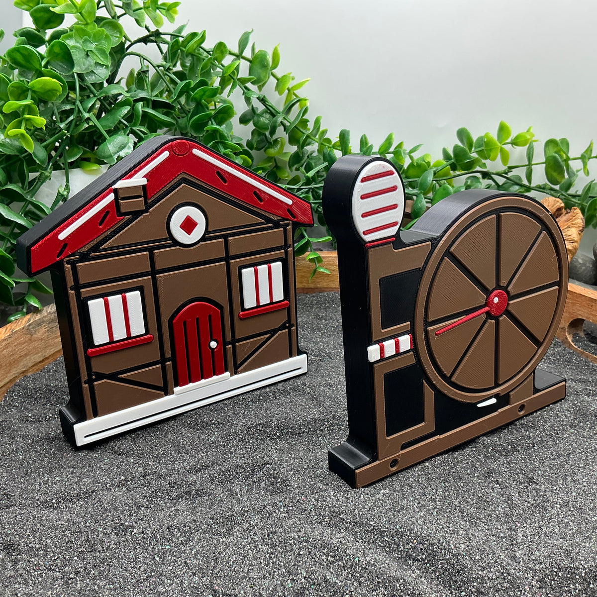 Dwarfs cottage and spinning-wheel scene prop standing together in a wooden tray