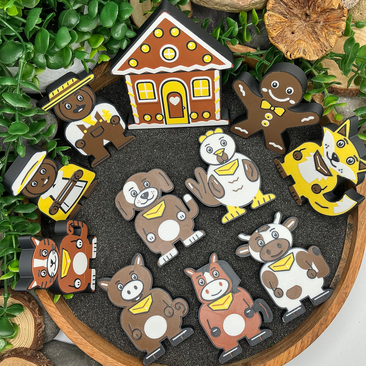 Gingerbread Man 11 piece story set laid out in a wooden tray with dark sand