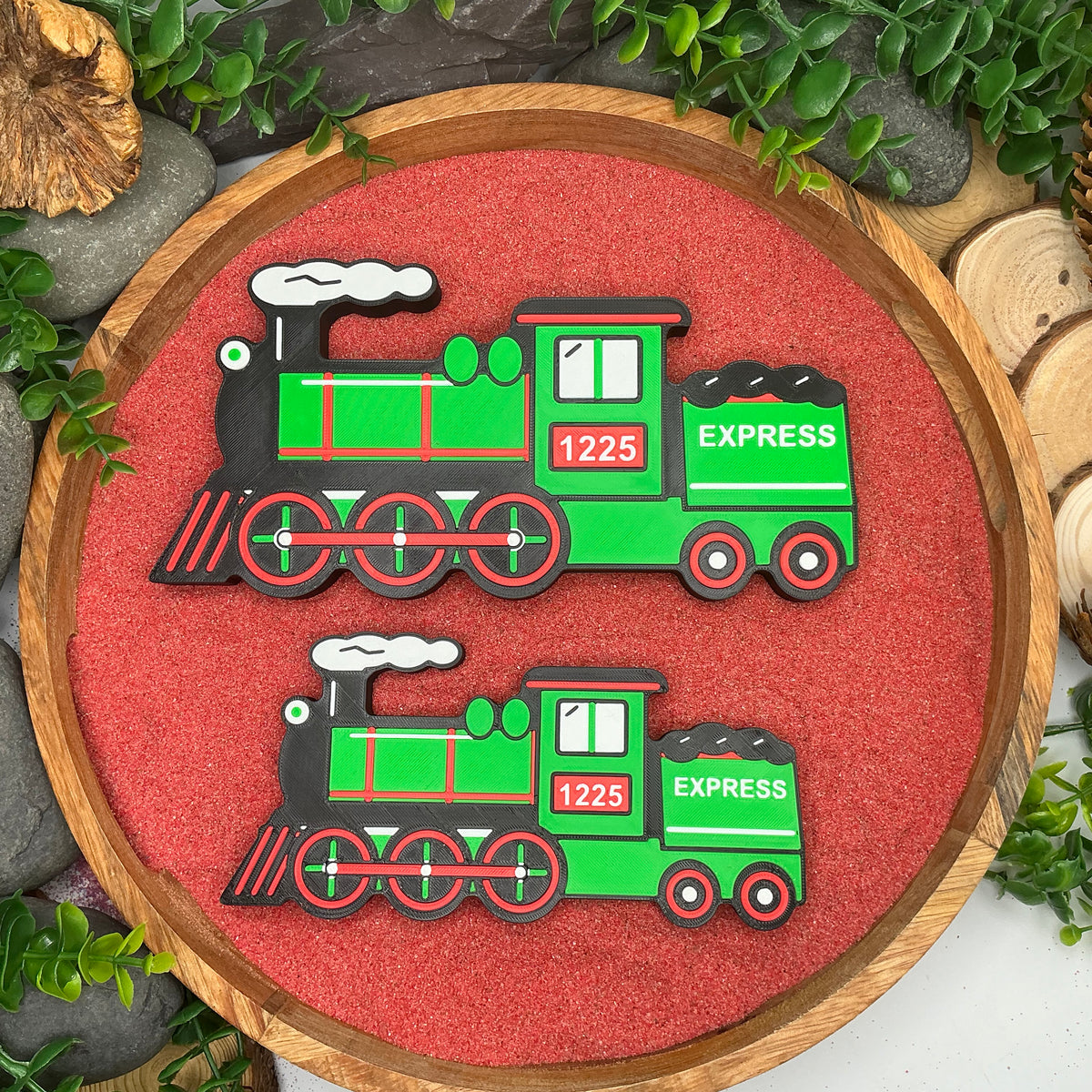 Large and Small Christmas express train pieces laid flat side by side for size comparison