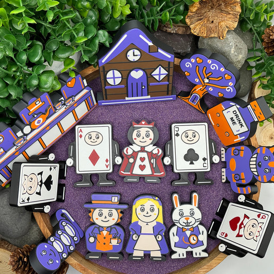 Alice in Wonderland 14-piece story set laid flat in a wooden tray, including blonde Alice, four playing-card characters, cottage and tea-party scene