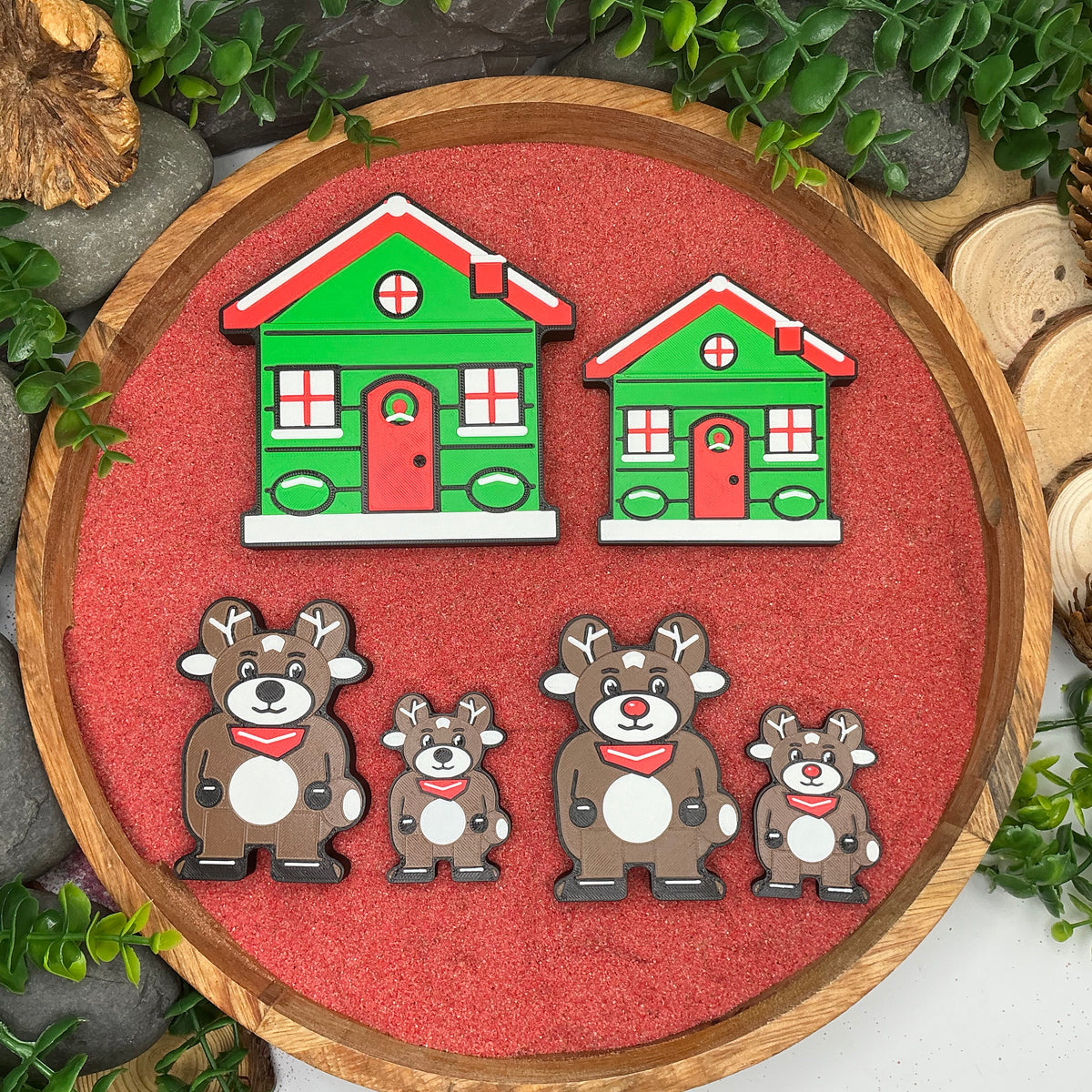 Large and Small Christmas cottages and both reindeer figures laid flat for size comparison