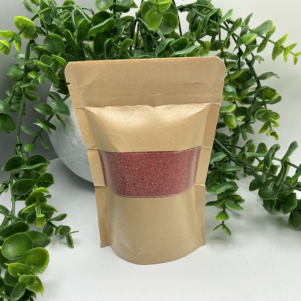 Red coloured play sand pouch
