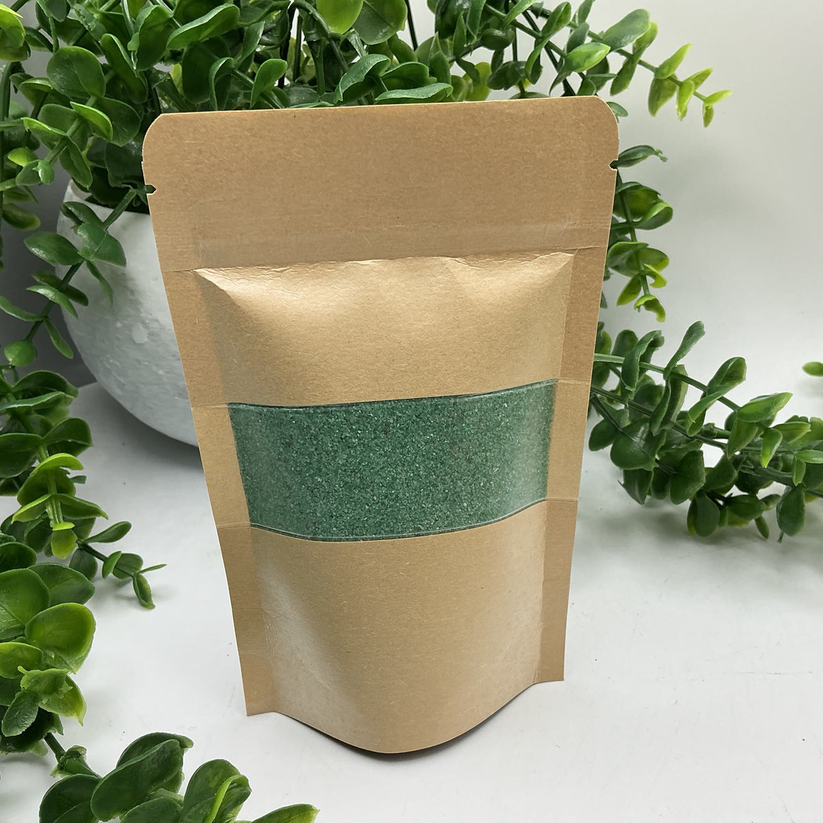 Green coloured play sand pouch